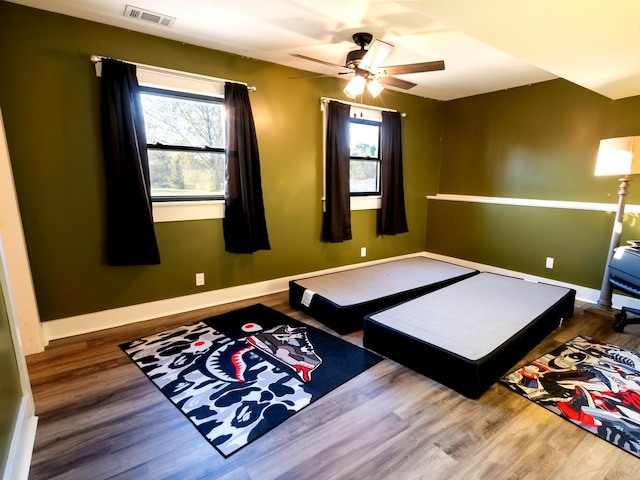 bedroom with ceiling fan and hardwood / wood-style floors