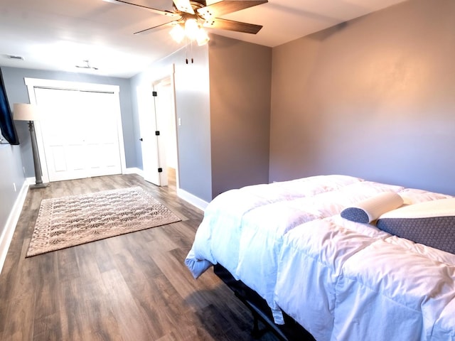 bedroom featuring ceiling fan and dark wood-type flooring