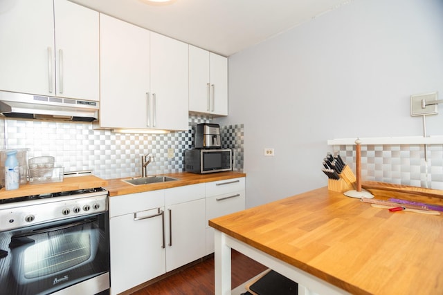 kitchen featuring butcher block countertops, white cabinetry, sink, and appliances with stainless steel finishes