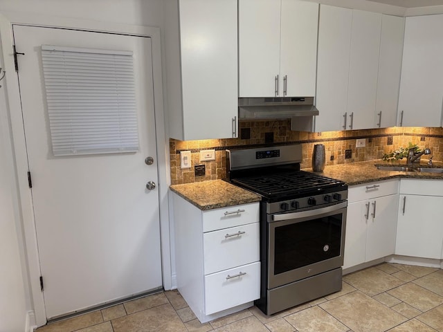 kitchen featuring white cabinets, stainless steel gas stove, tasteful backsplash, and sink