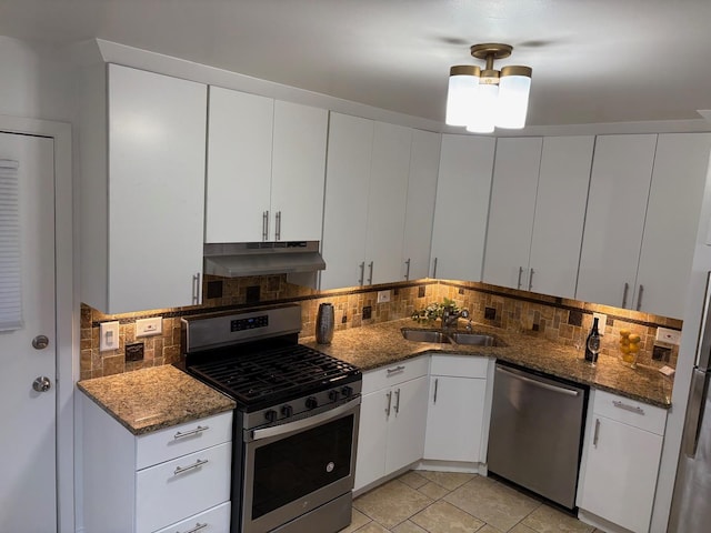 kitchen with decorative backsplash, white cabinetry, sink, and appliances with stainless steel finishes