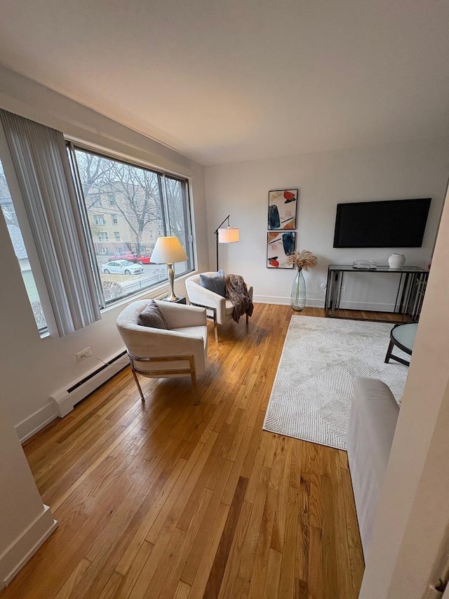 living room with light hardwood / wood-style flooring and a baseboard radiator