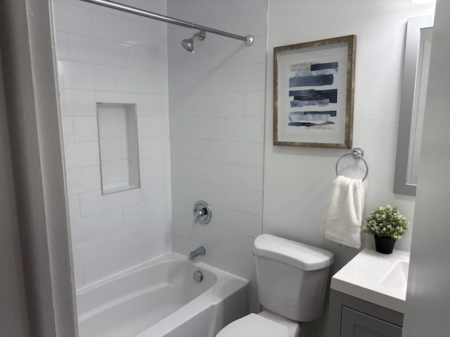 full bathroom with vanity, tiled shower / bath combo, and toilet