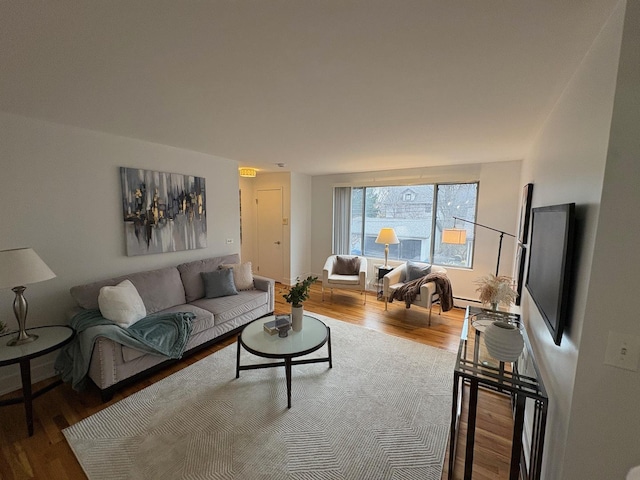 living room with hardwood / wood-style floors and baseboard heating