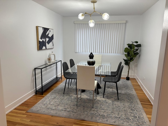 dining room featuring an inviting chandelier and hardwood / wood-style flooring