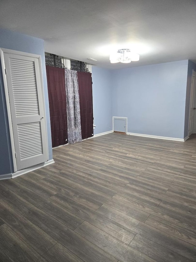 unfurnished room featuring dark hardwood / wood-style flooring