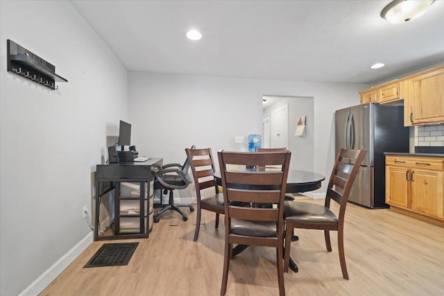 dining space featuring light wood-type flooring