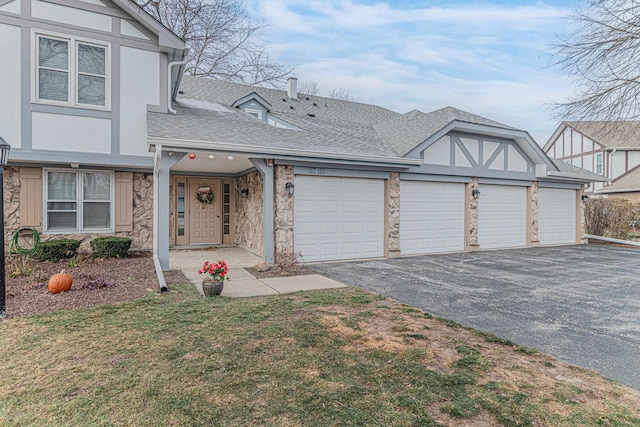 view of front of house with a front yard and a garage