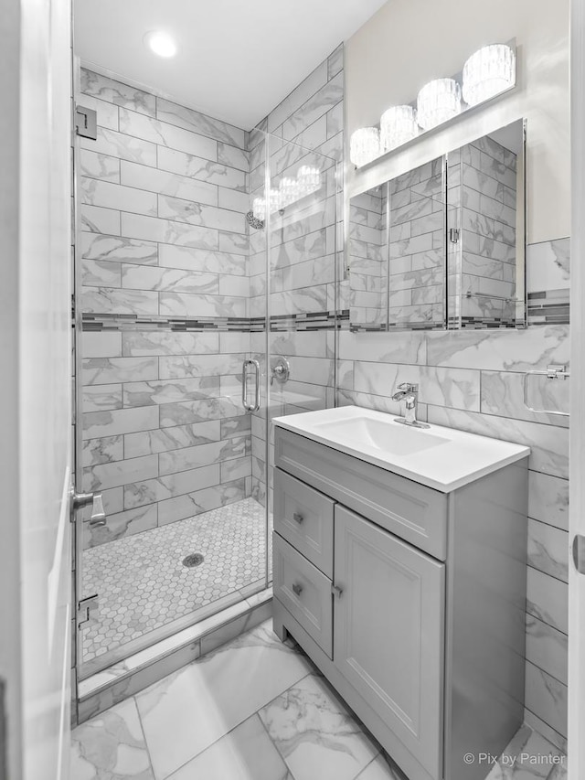 bathroom with vanity and a shower with shower door