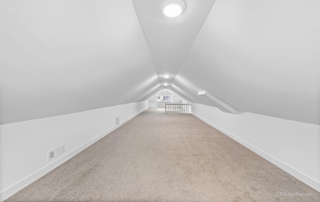 bonus room featuring carpet and vaulted ceiling