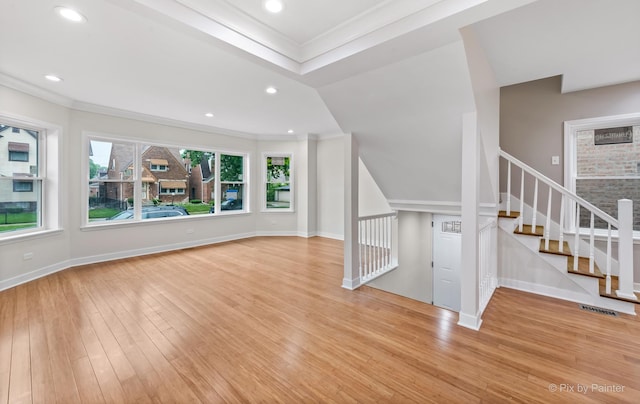 unfurnished living room with light hardwood / wood-style floors and ornamental molding