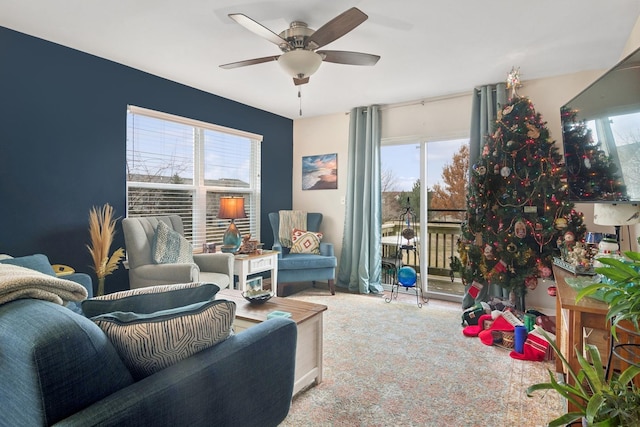 carpeted living room with ceiling fan and a healthy amount of sunlight