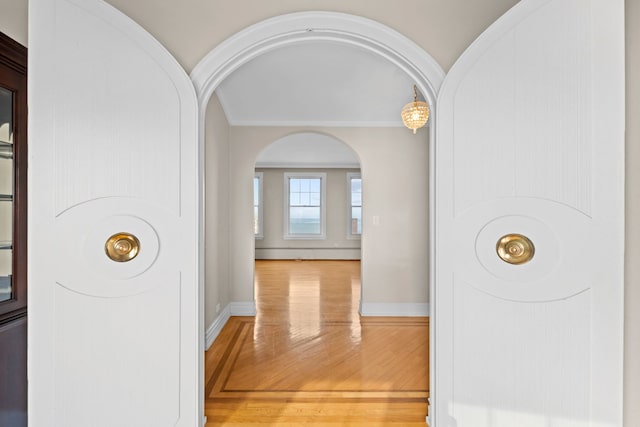 corridor featuring hardwood / wood-style flooring and crown molding