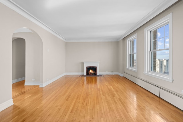 unfurnished living room with crown molding, light hardwood / wood-style flooring, and a baseboard radiator