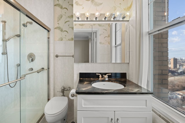 bathroom with vanity, toilet, and a shower with shower door