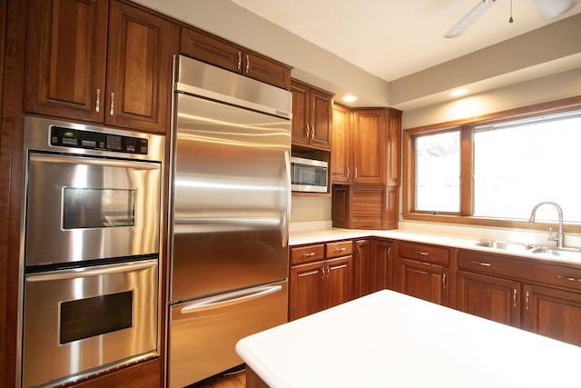 kitchen featuring ceiling fan, sink, and appliances with stainless steel finishes