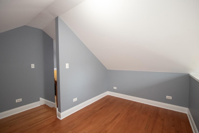 bonus room featuring hardwood / wood-style flooring and vaulted ceiling