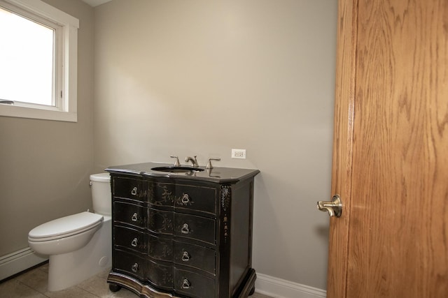 bathroom featuring baseboard heating, toilet, and vanity