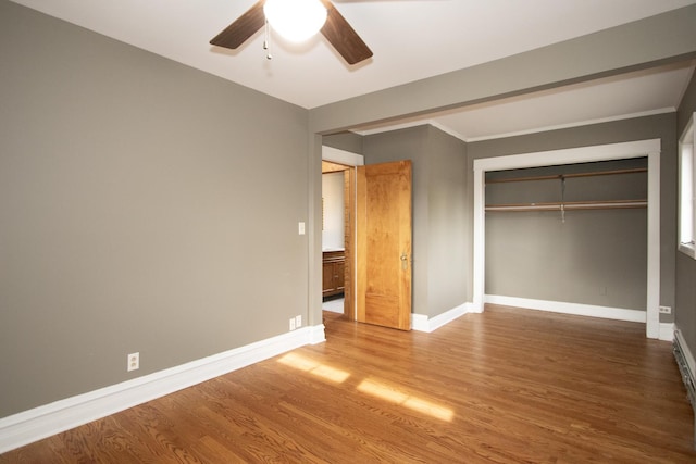 unfurnished bedroom with ceiling fan, a closet, and hardwood / wood-style floors