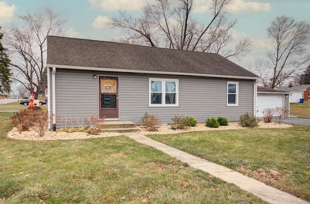 view of front of home featuring a garage and a front lawn