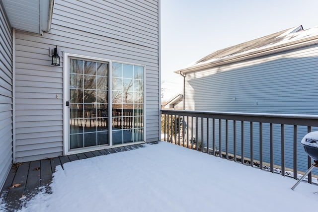 view of snow covered back of property