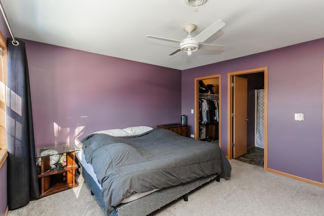 bedroom with ceiling fan, a closet, carpet, and a spacious closet