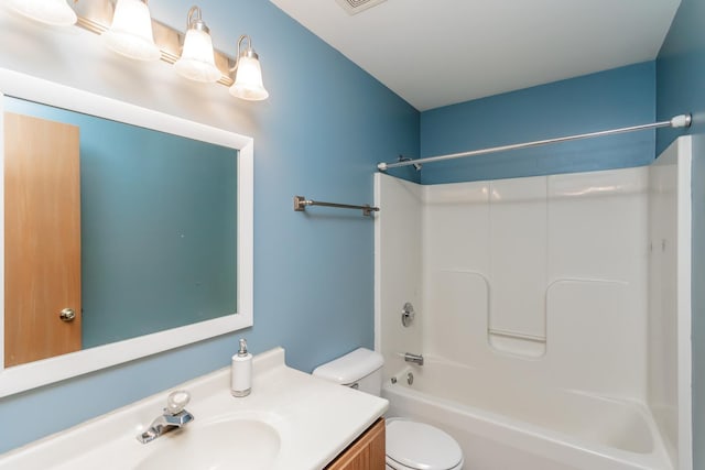 full bathroom featuring vanity, bathtub / shower combination, and toilet