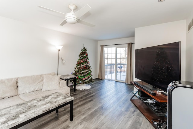 living room with wood-type flooring and ceiling fan