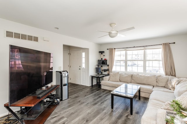 living room featuring ceiling fan and hardwood / wood-style floors