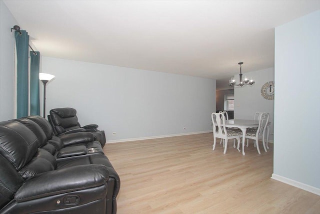 living room featuring a chandelier and light wood-type flooring