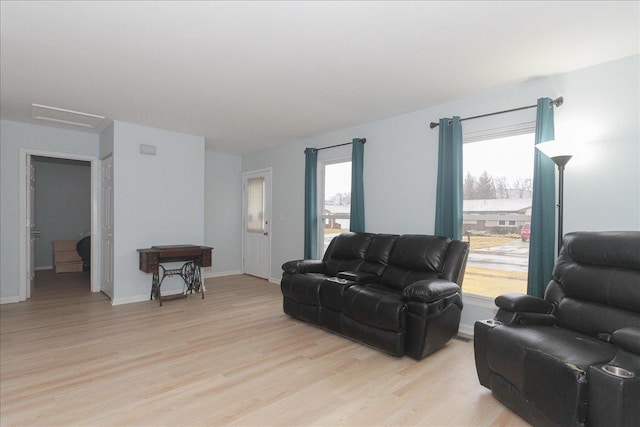 living room featuring plenty of natural light and light hardwood / wood-style floors