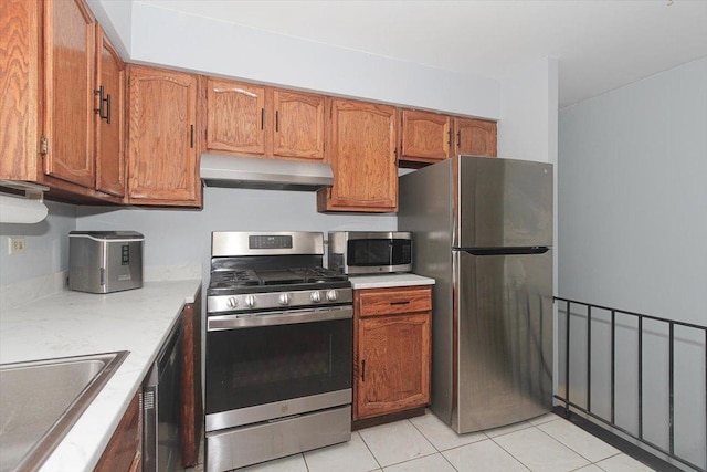 kitchen featuring appliances with stainless steel finishes, sink, and light tile patterned floors