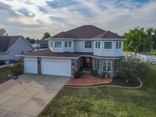 front of property featuring a garage and a front lawn