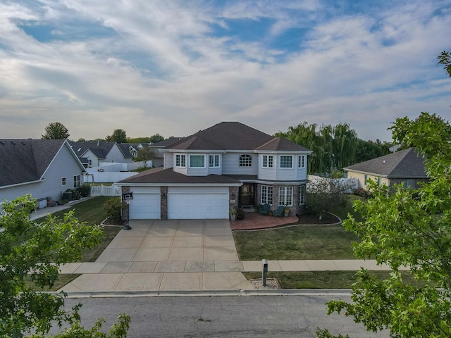 view of front facade with a front yard and a garage