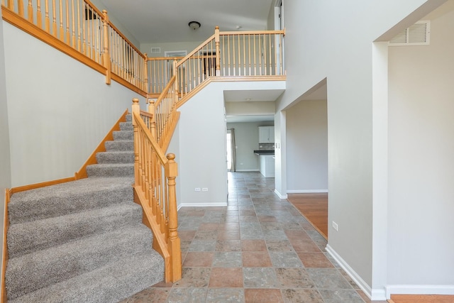 staircase with a high ceiling