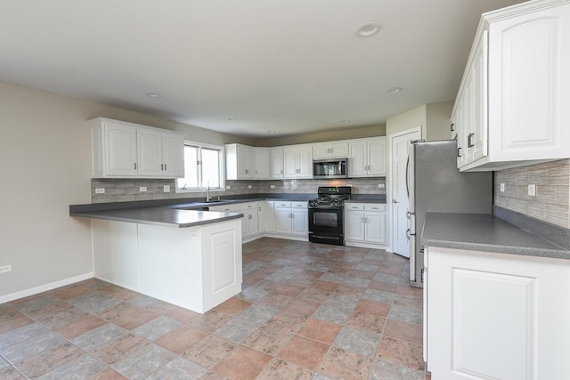 kitchen featuring kitchen peninsula, stainless steel appliances, white cabinetry, and tasteful backsplash