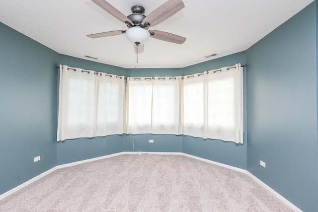 empty room with ceiling fan and carpet