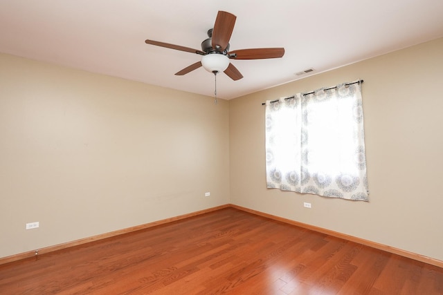 spare room with hardwood / wood-style floors and ceiling fan