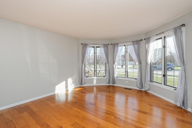 unfurnished room with light wood-type flooring