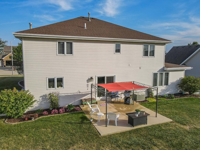 back of house featuring cooling unit, a patio area, and a yard