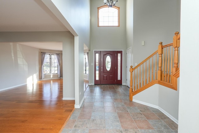 foyer featuring hardwood / wood-style floors, a towering ceiling, and a wealth of natural light