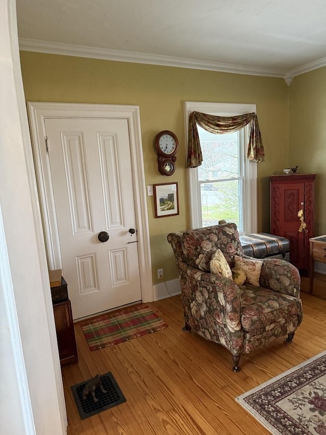 sitting room featuring hardwood / wood-style flooring and ornamental molding