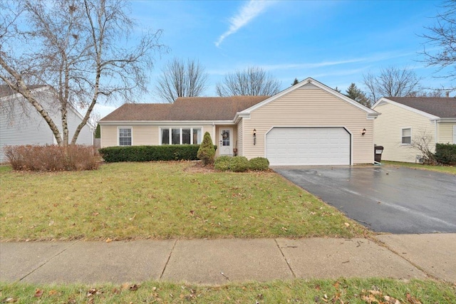 ranch-style house with a garage and a front lawn