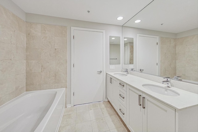 bathroom with vanity, a bathtub, and tile patterned flooring