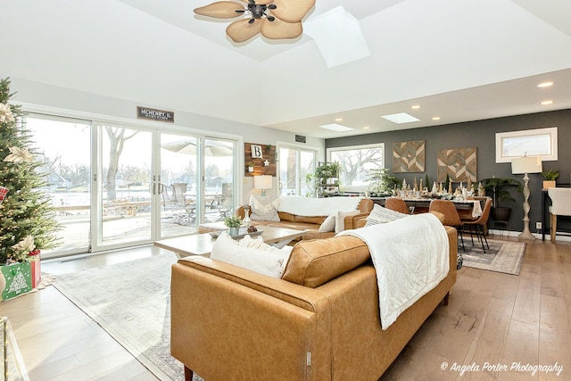 living room featuring light hardwood / wood-style flooring, plenty of natural light, and ceiling fan