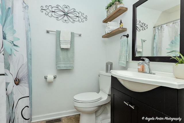 bathroom featuring tile patterned flooring, vanity, and toilet