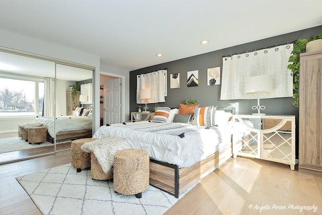 bedroom with hardwood / wood-style floors and a closet