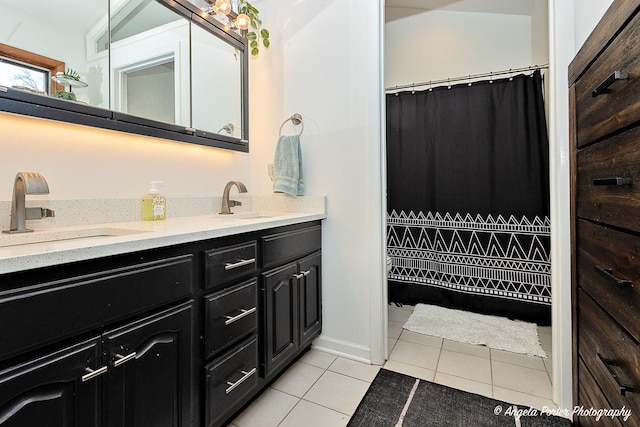 bathroom with tile patterned floors, vanity, and lofted ceiling