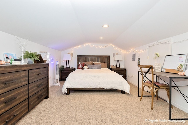 carpeted bedroom with lofted ceiling