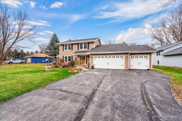 view of front property featuring a front yard and a garage